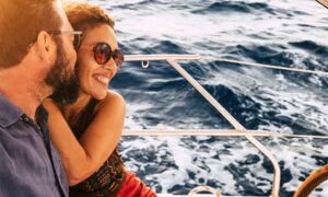 Couple in happiness enjoy a sail tour in yacht