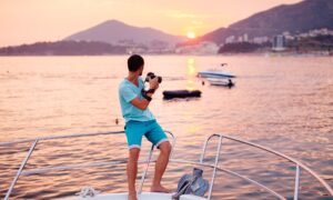 tourist man travel on yacht at sunset